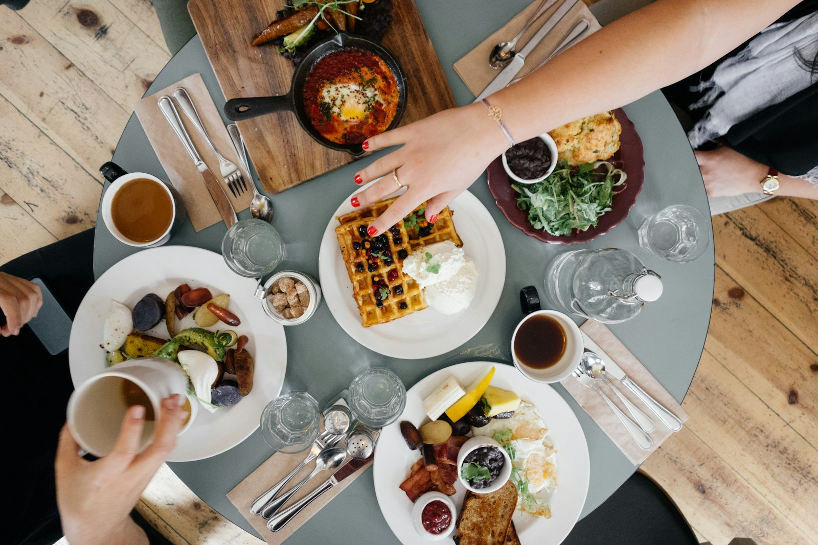 Friends around a brunch table seen from above