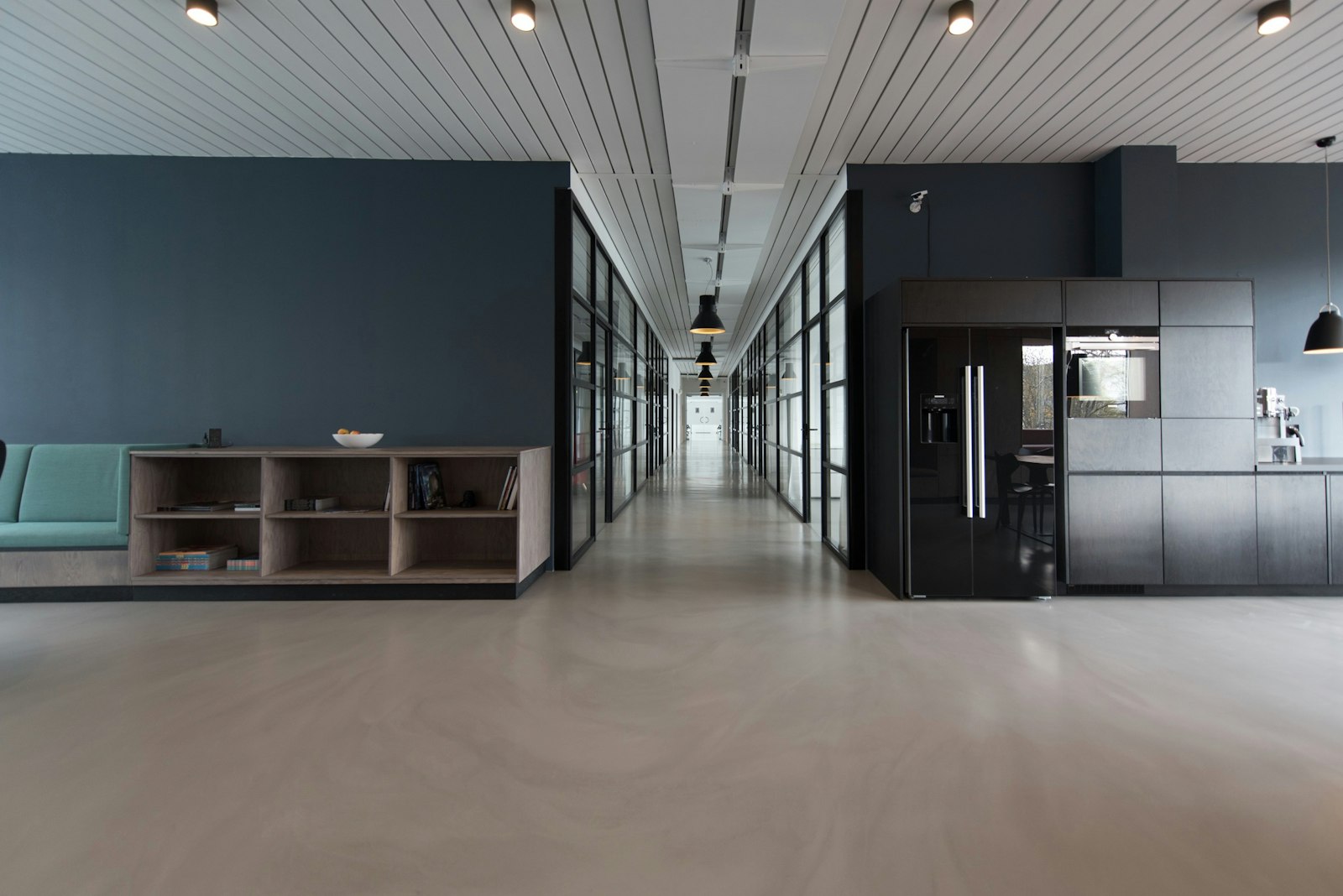 An open-plan interior with a kitchen along one side