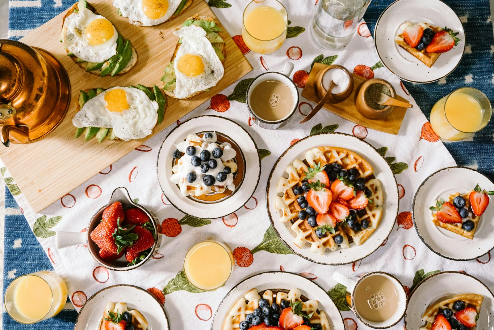 A brunch spread from above with eggs, waffles and juice