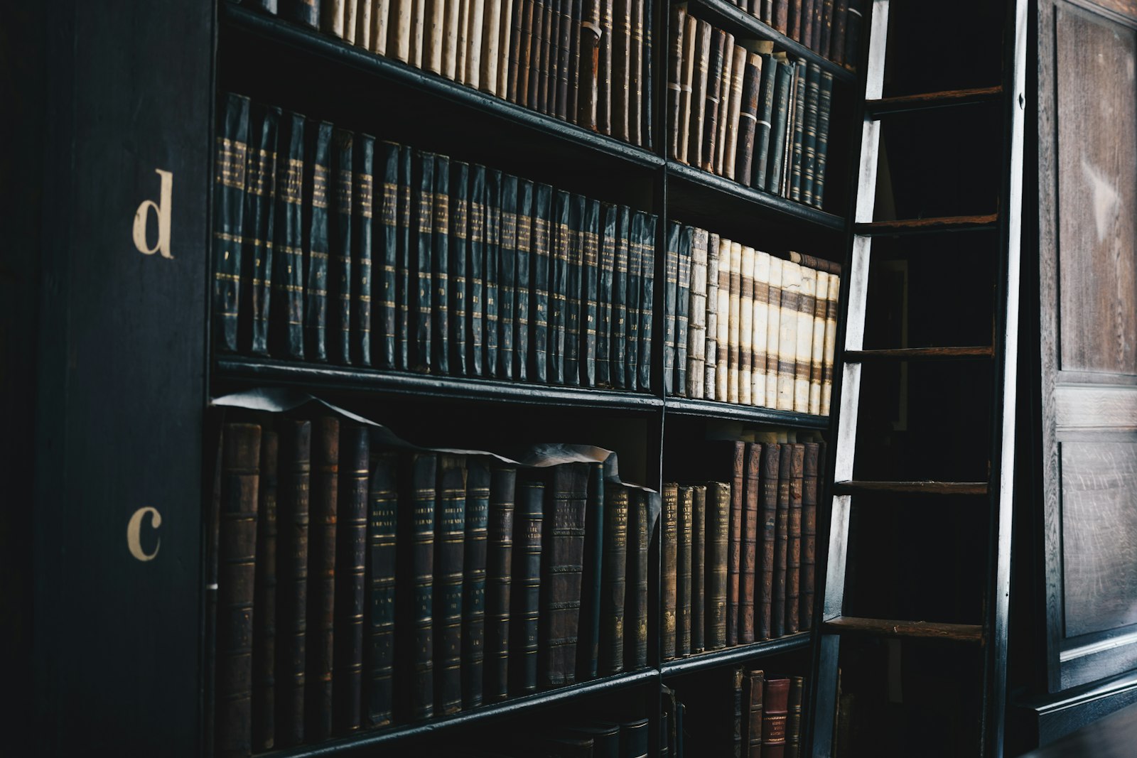 A dark wooden bookcase of bound law reports