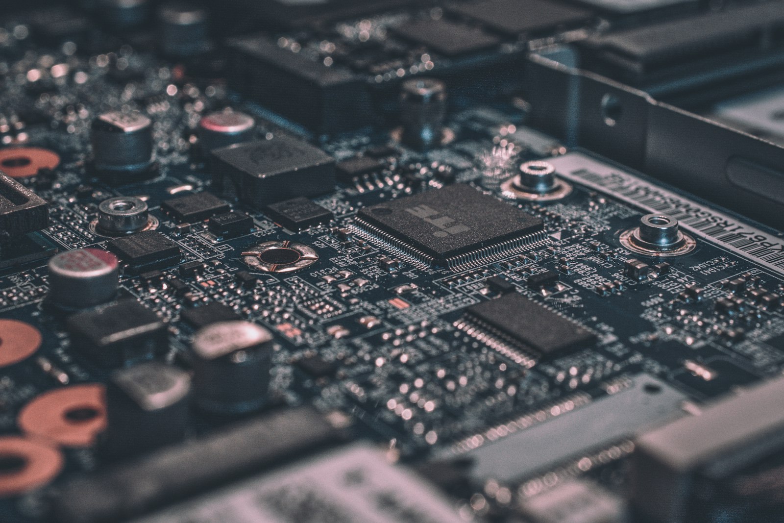A macro photograph of a dark circuit board