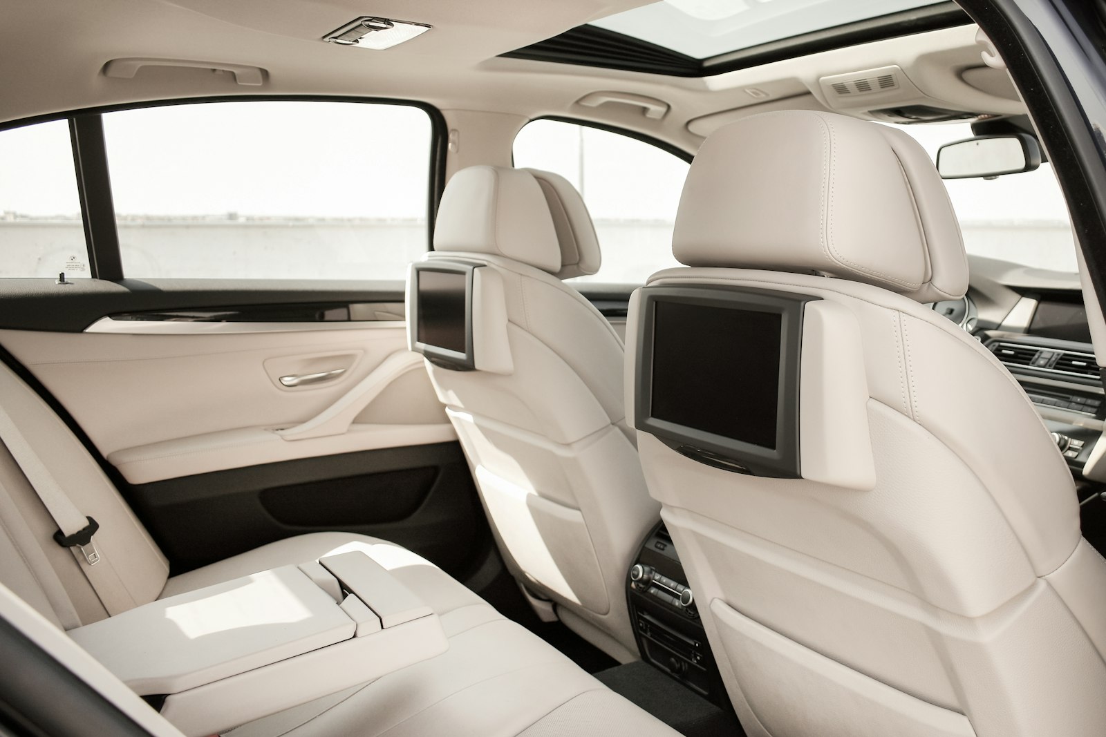 Cream leather rear seats of a saloon in daylight