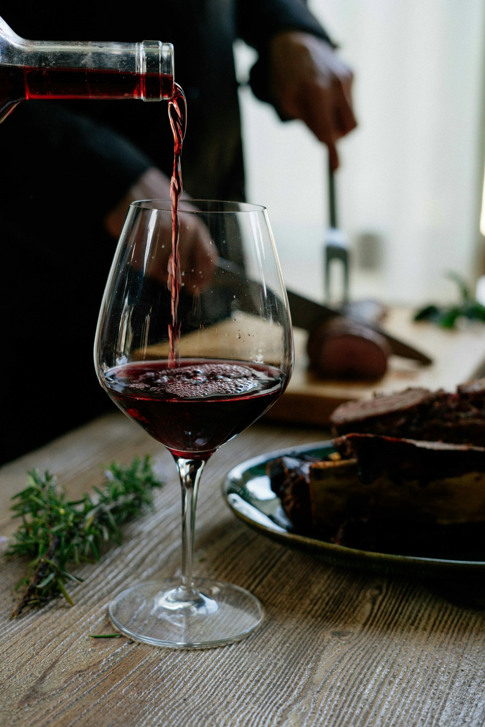 Red wine poured beside a plate