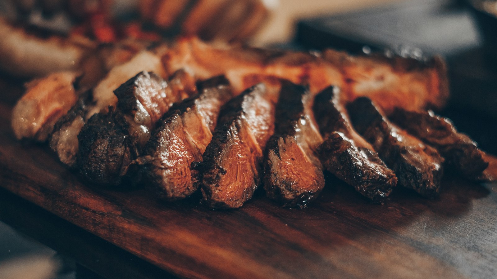 A sliced steak fanned out on a board