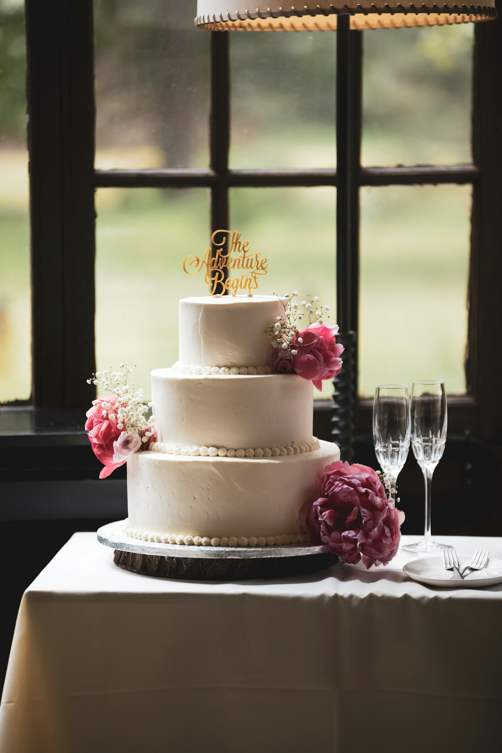A three-tier white cake with flowers