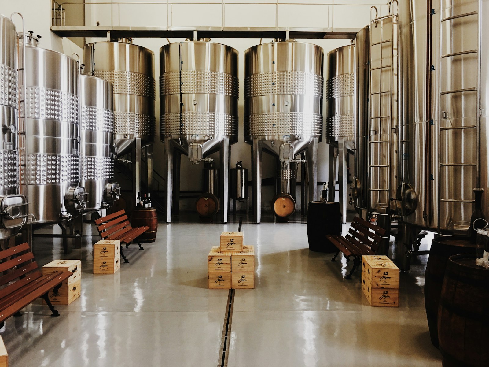A hall of fermentation tanks with wooden benches