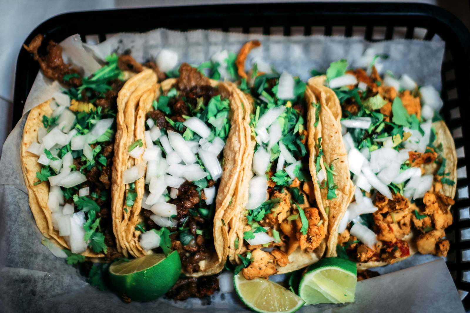 Tacos with onion, coriander and lime in a basket