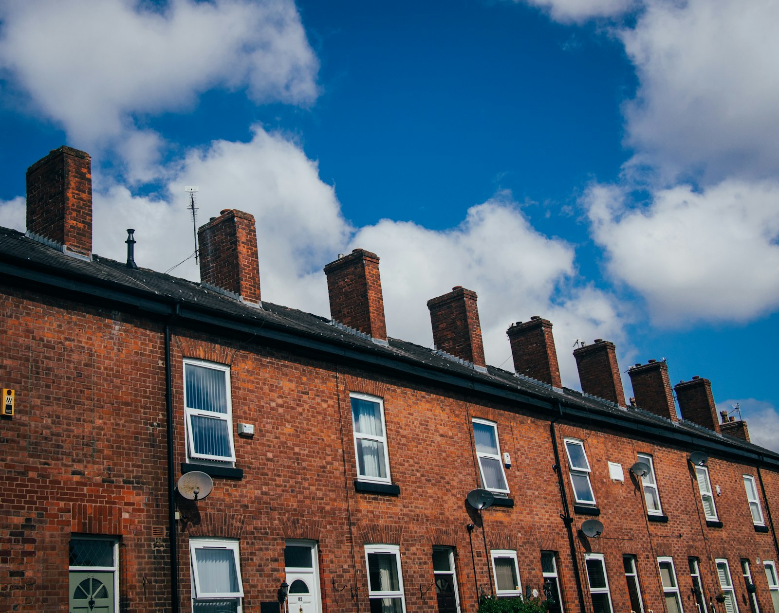 A red-brick Victorian terrace with chimneys