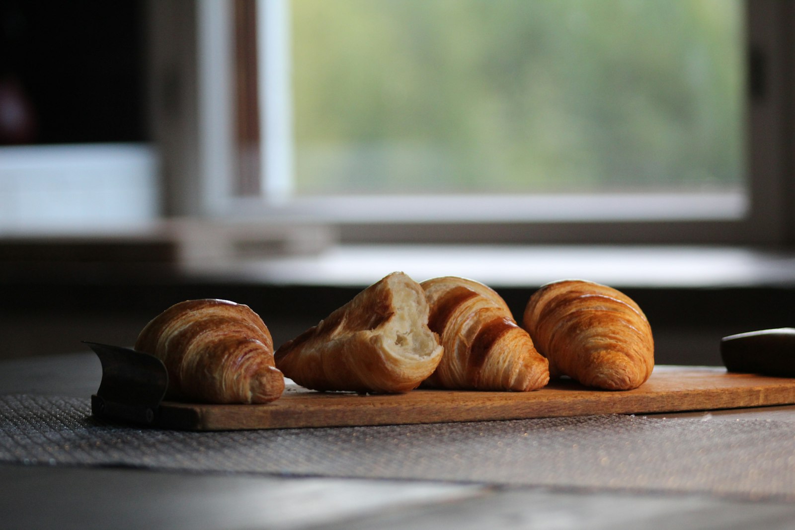 Croissants on a board by a window