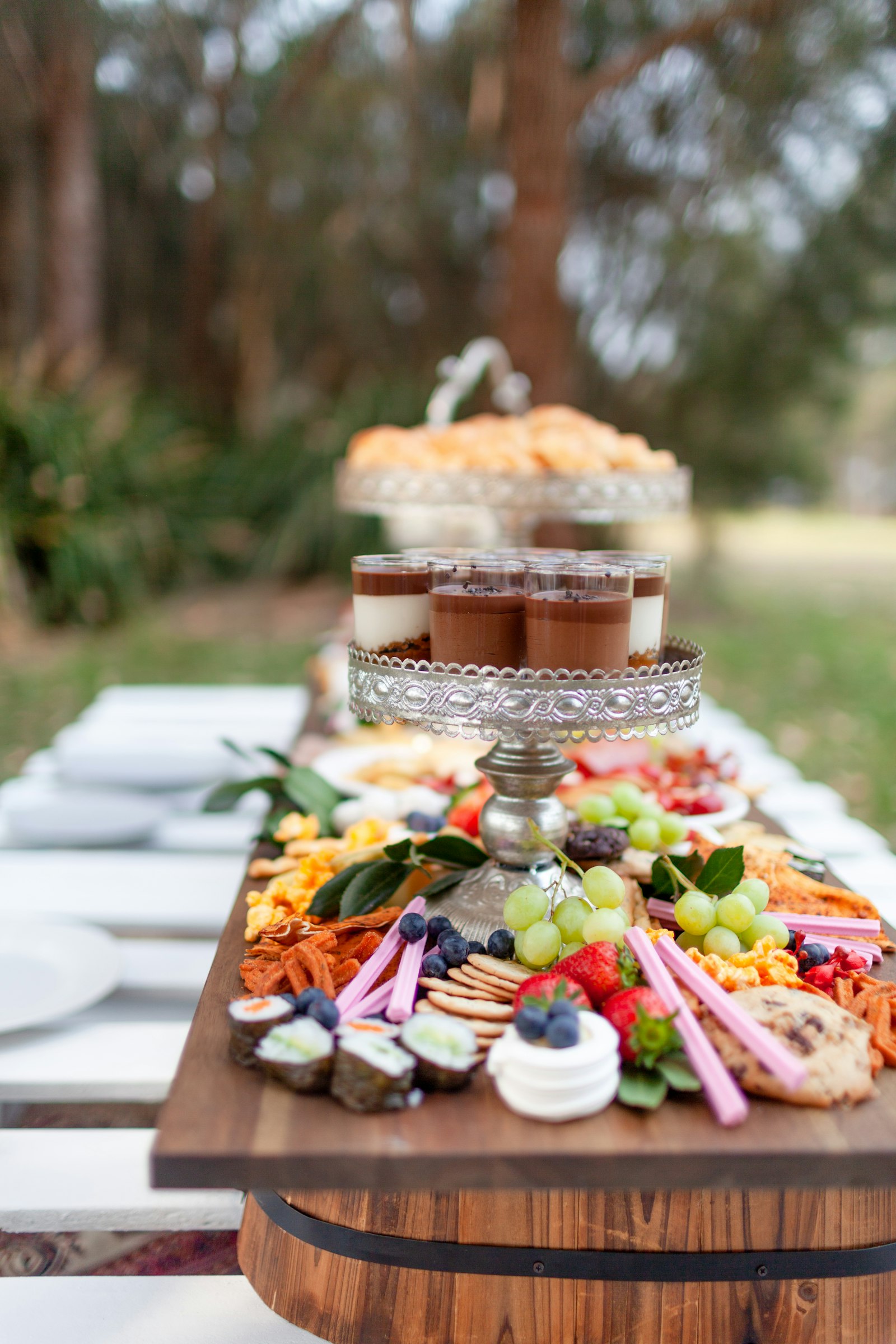 An outdoor grazing table with desserts