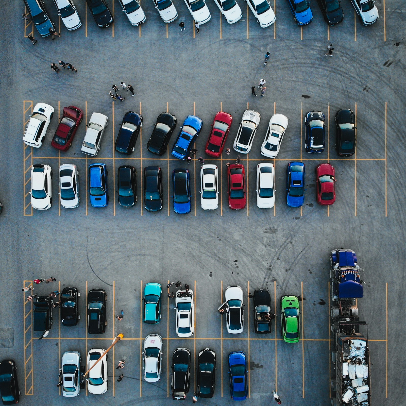 An aerial view of rows of cars in a car park
