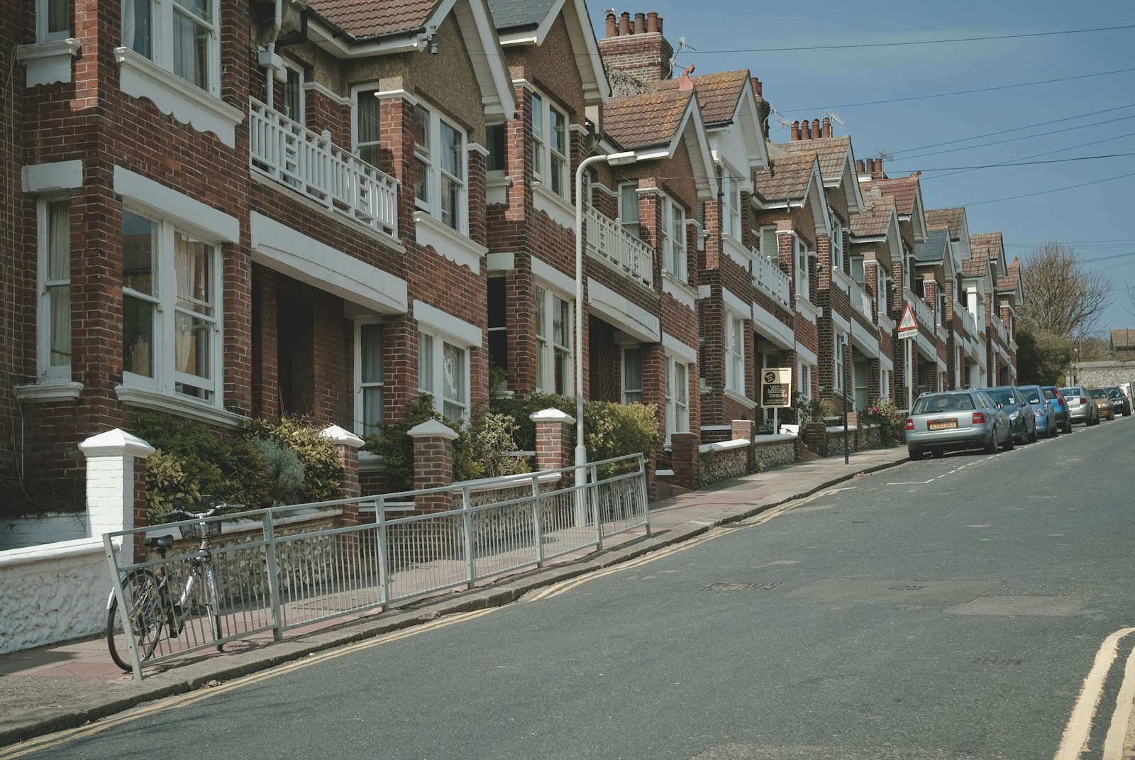A red-brick terrace street running downhill