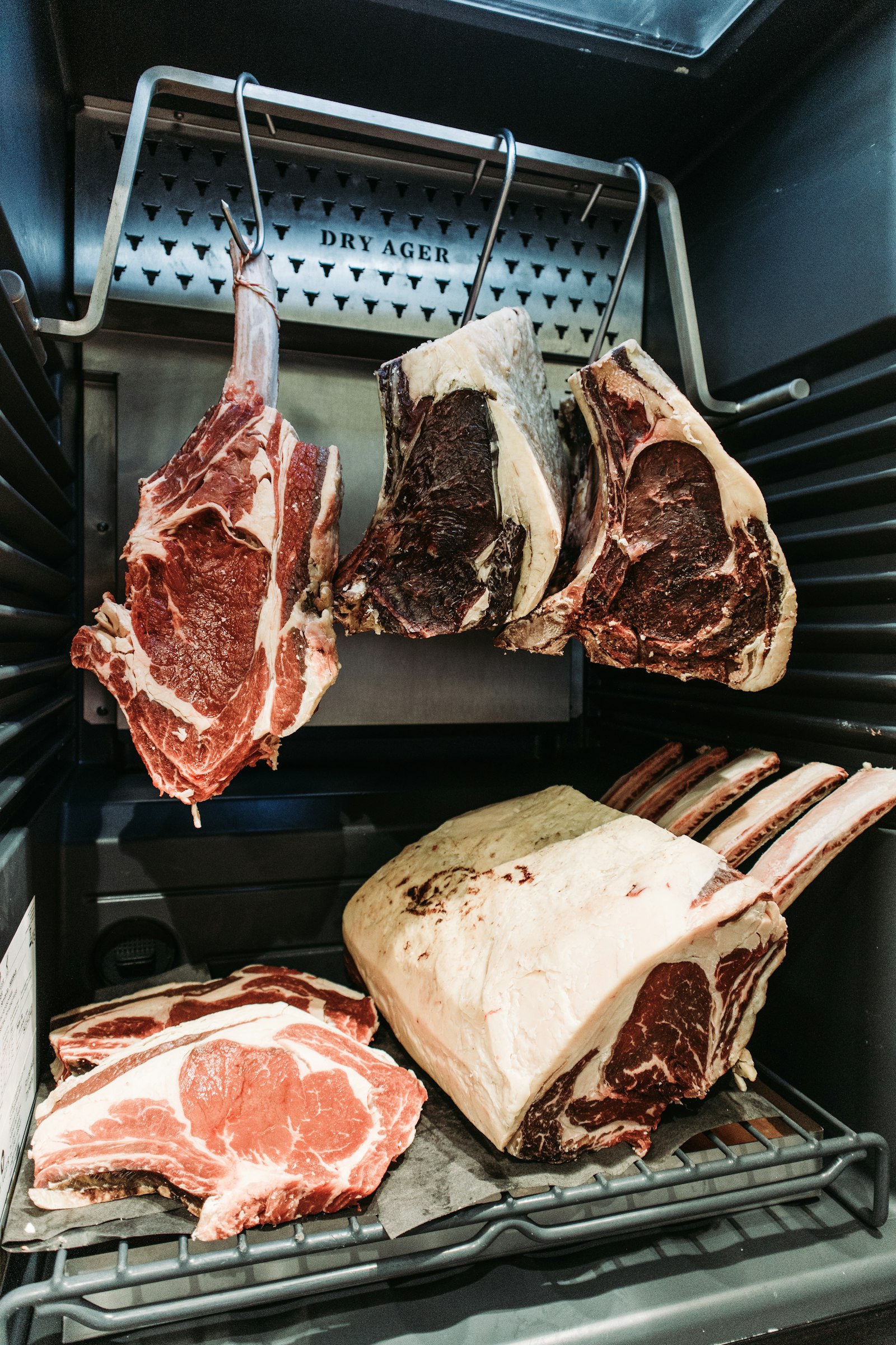 A dry-ageing cabinet with hanging rib cuts