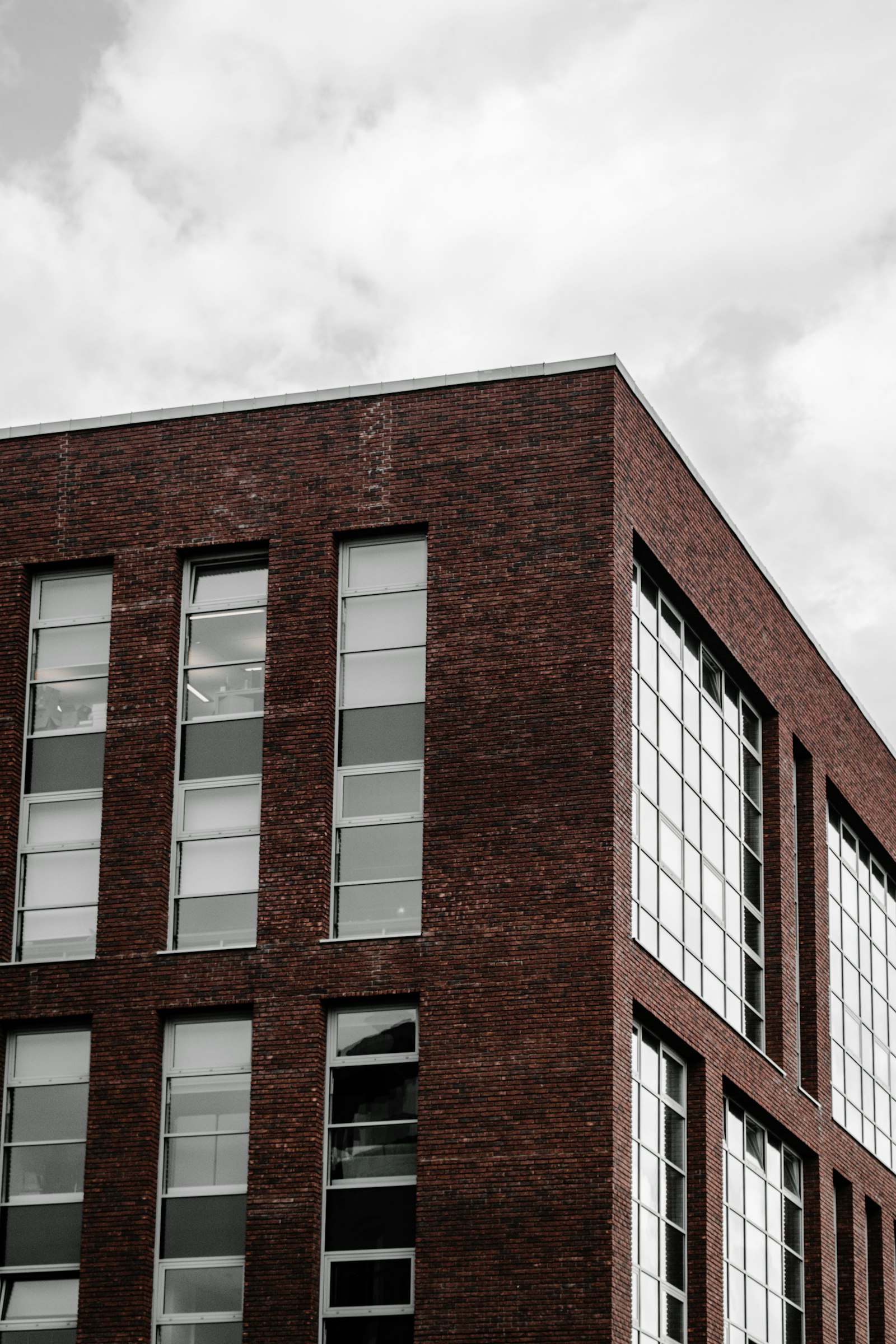 A dark-brick block with a grid of deep windows