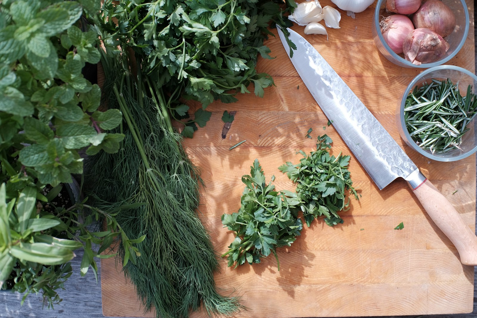 Chopped parsley, dill and shallots on a board