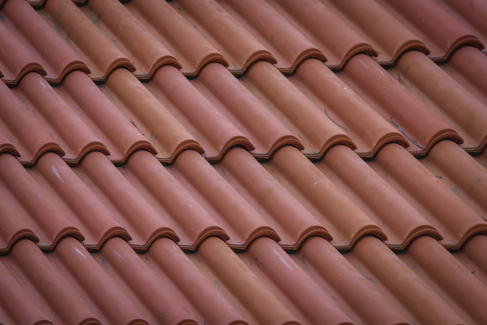 Close-up of overlapping terracotta clay roof tiles