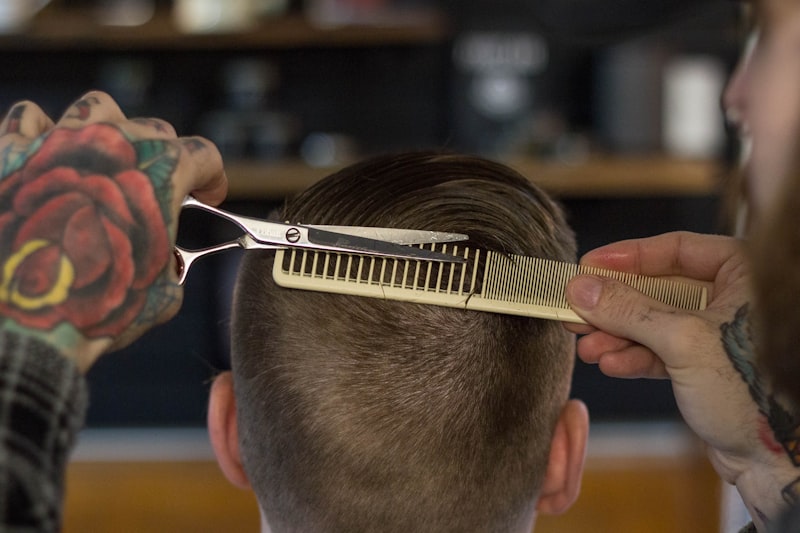 A comb and scissors in the stylist's hand