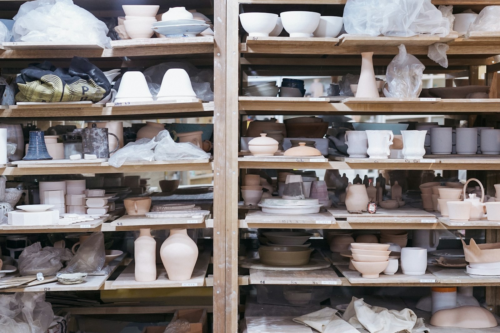 Studio shelves of glazed and bisque pots
