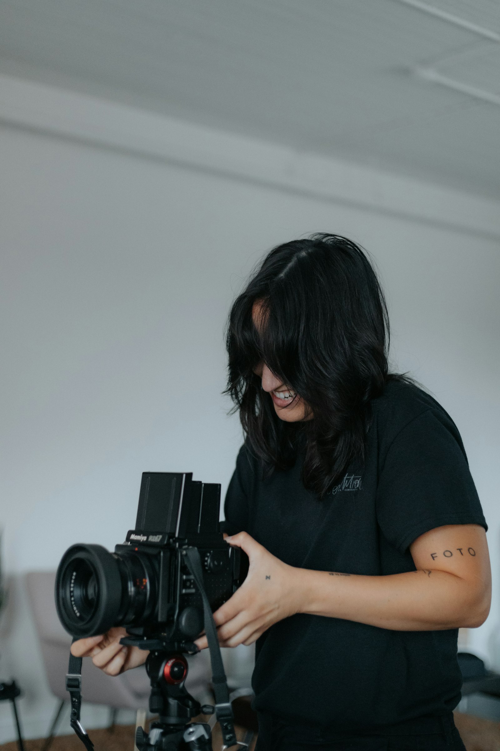 The photographer adjusting a medium-format camera on a tripod