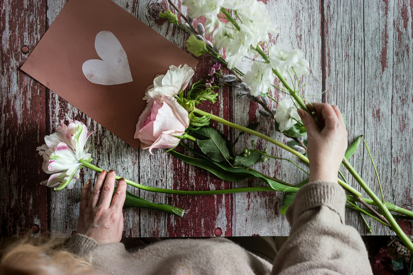 Roses laid out on red-painted wood