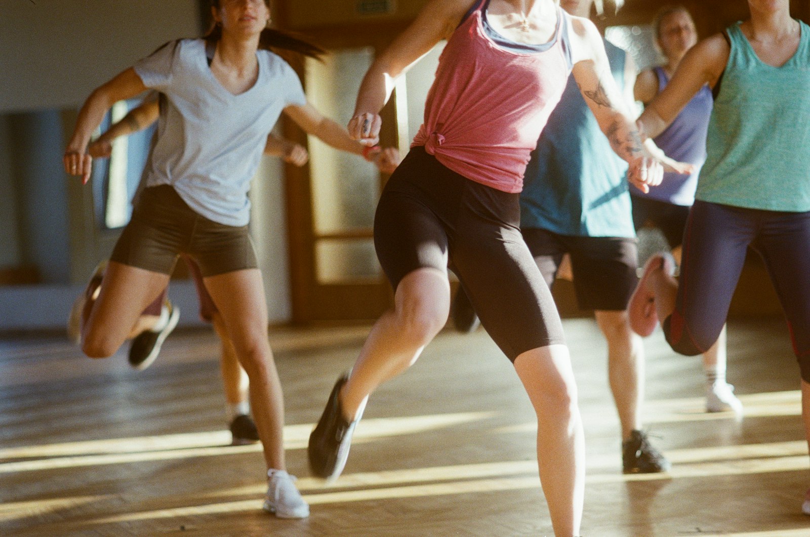 A dance fitness class mid-jump
