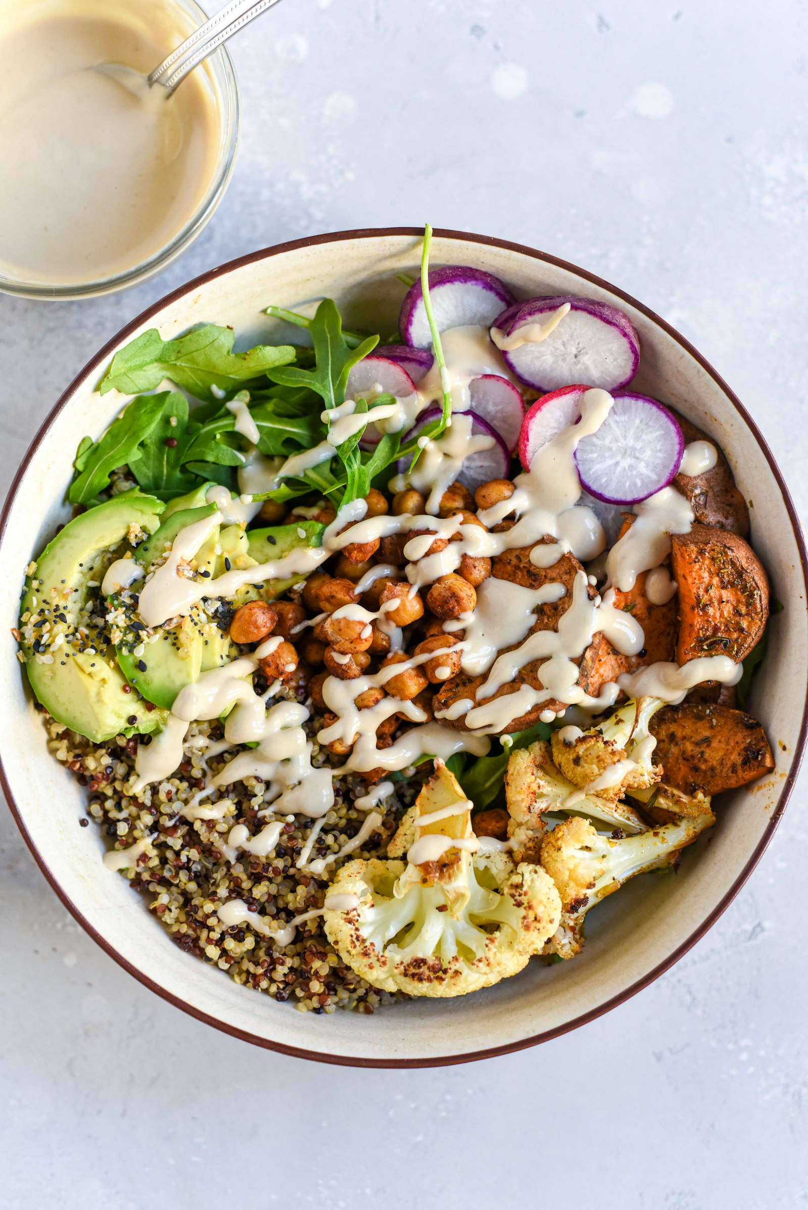 A grain bowl with roasted chickpeas and tahini