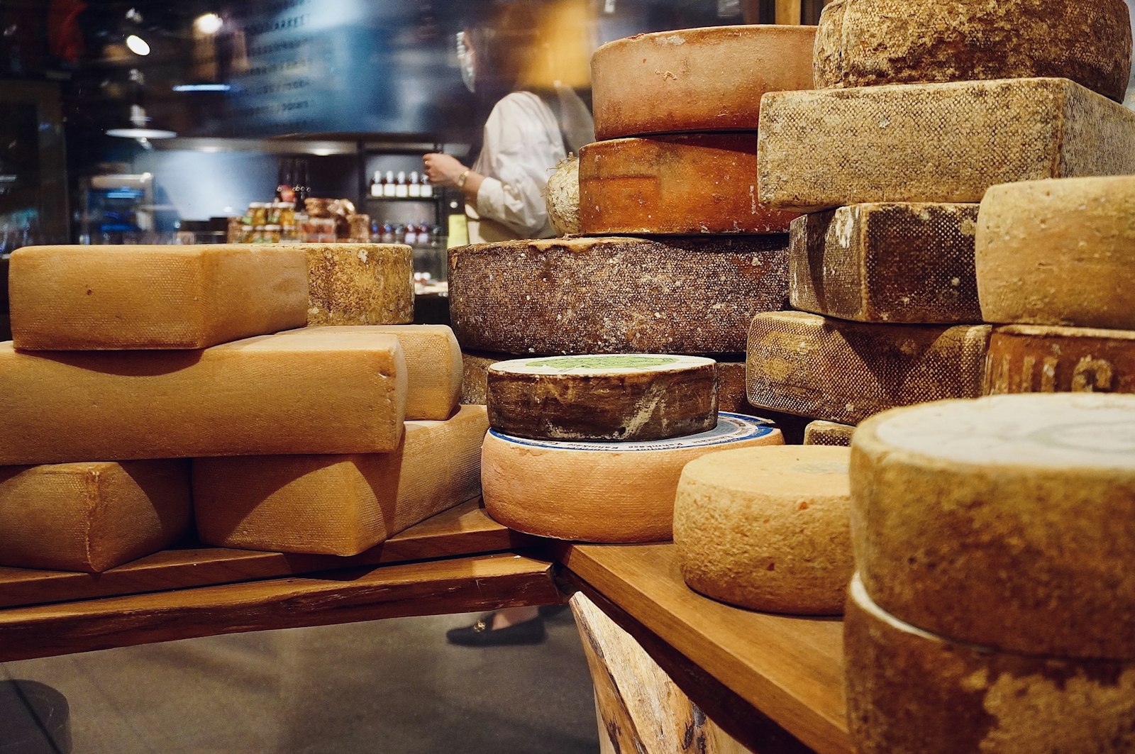 Stacked cheese wheels on wooden boards