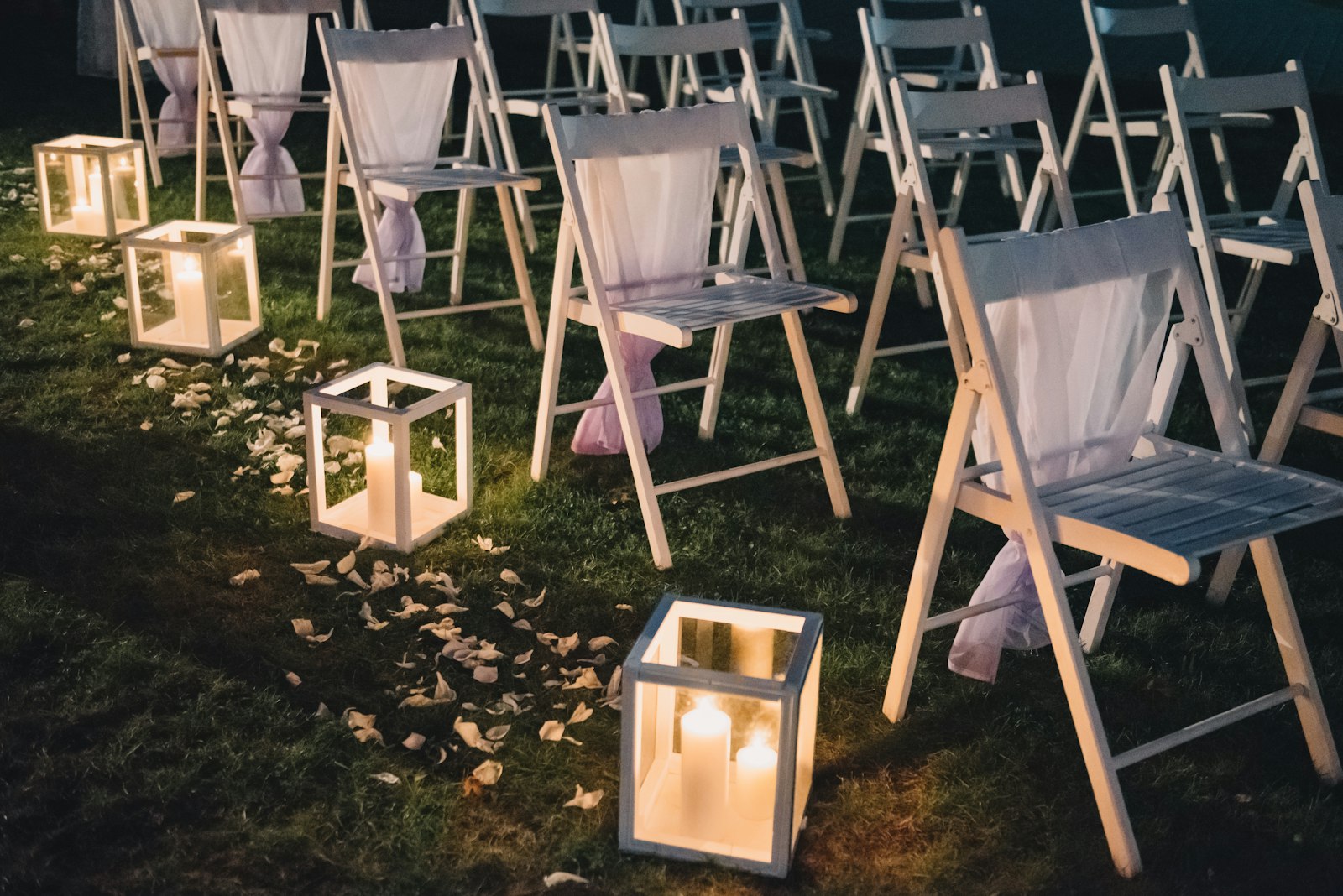 An aisle at dusk with lanterns