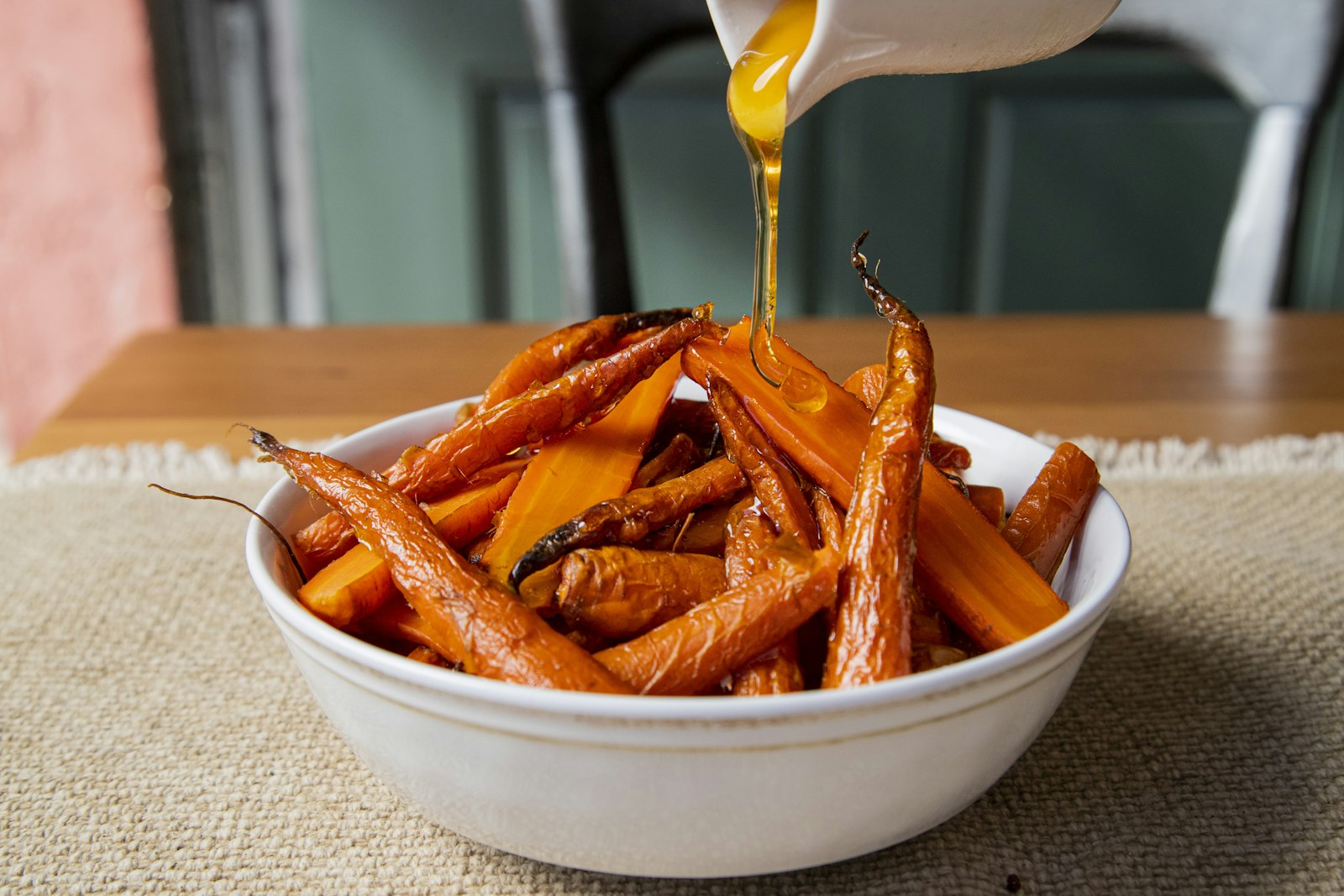 Oil poured over roasted carrots and squash