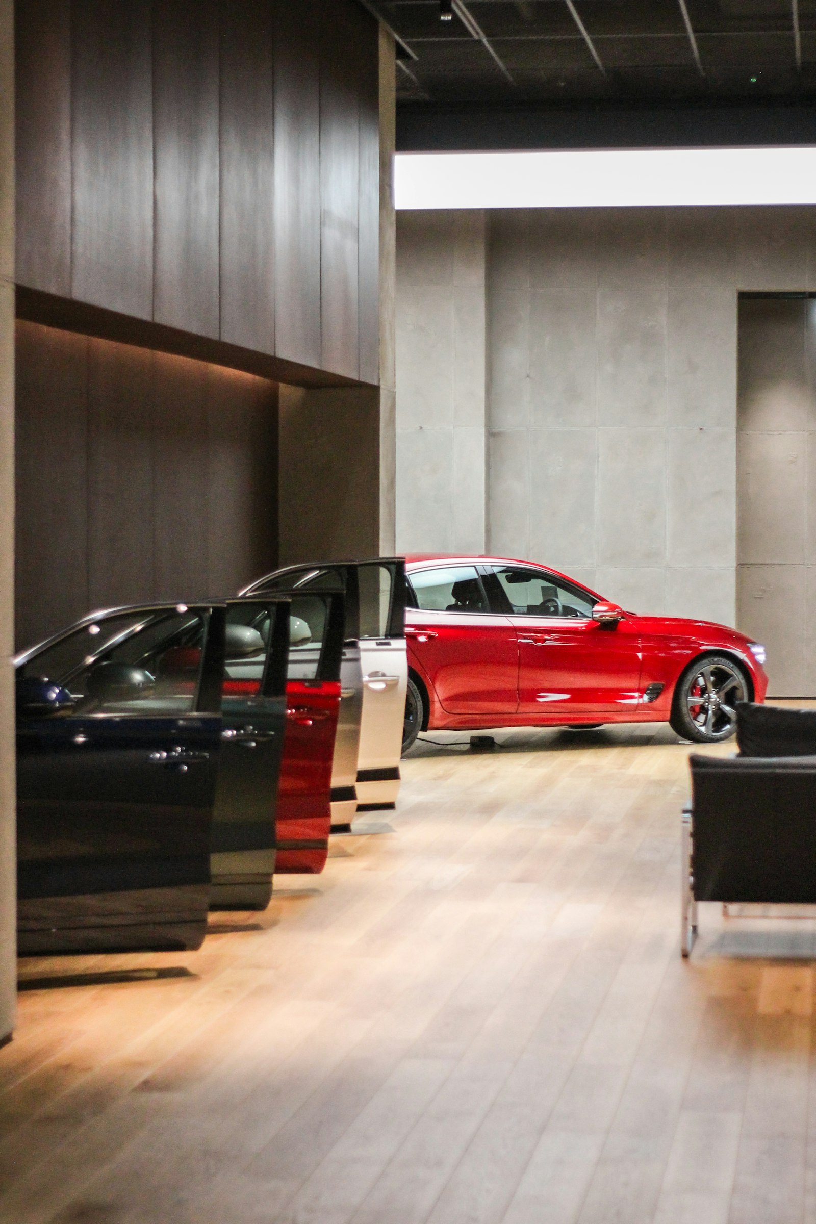 A showroom row of cars with their doors open