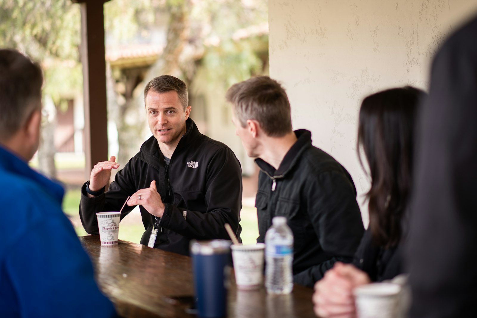 A small group chatting over coffee at a table