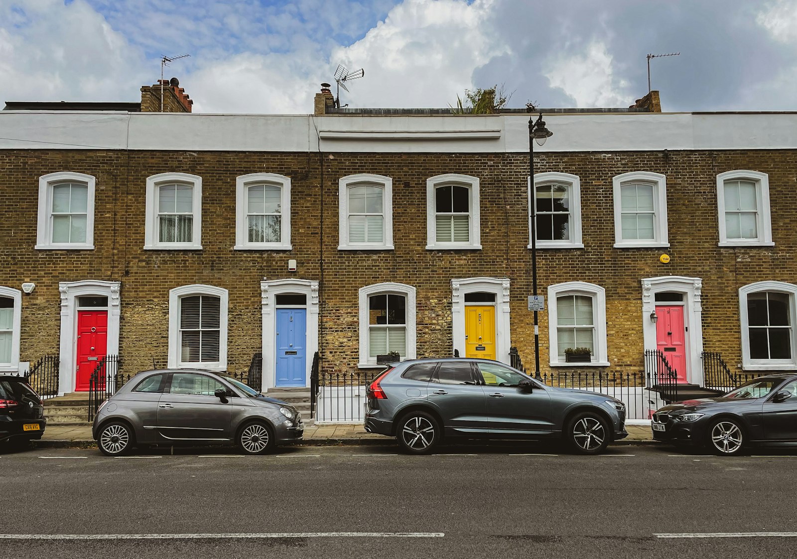 A Georgian brick terrace with coloured front doors