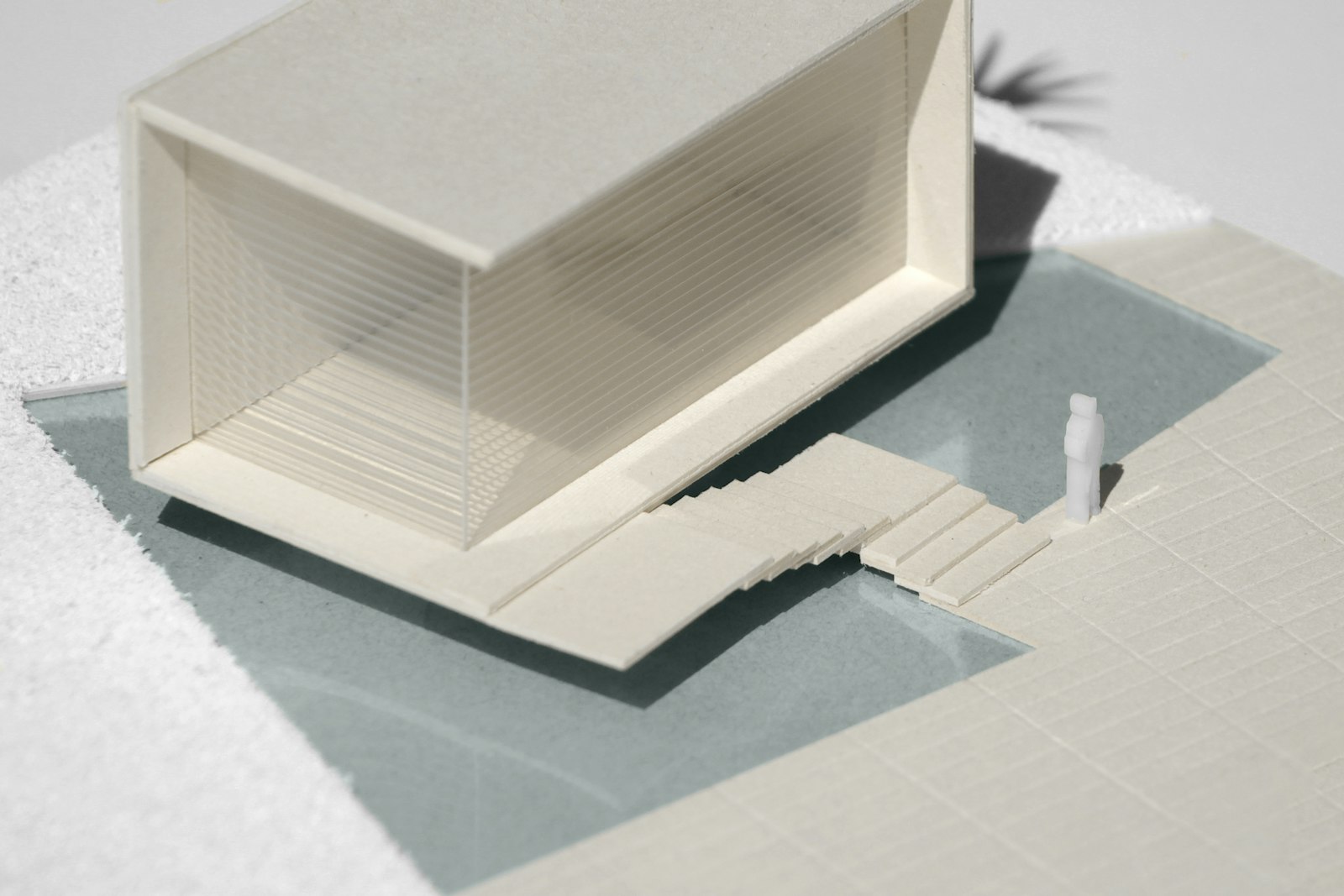 A white card model of a cantilevered house