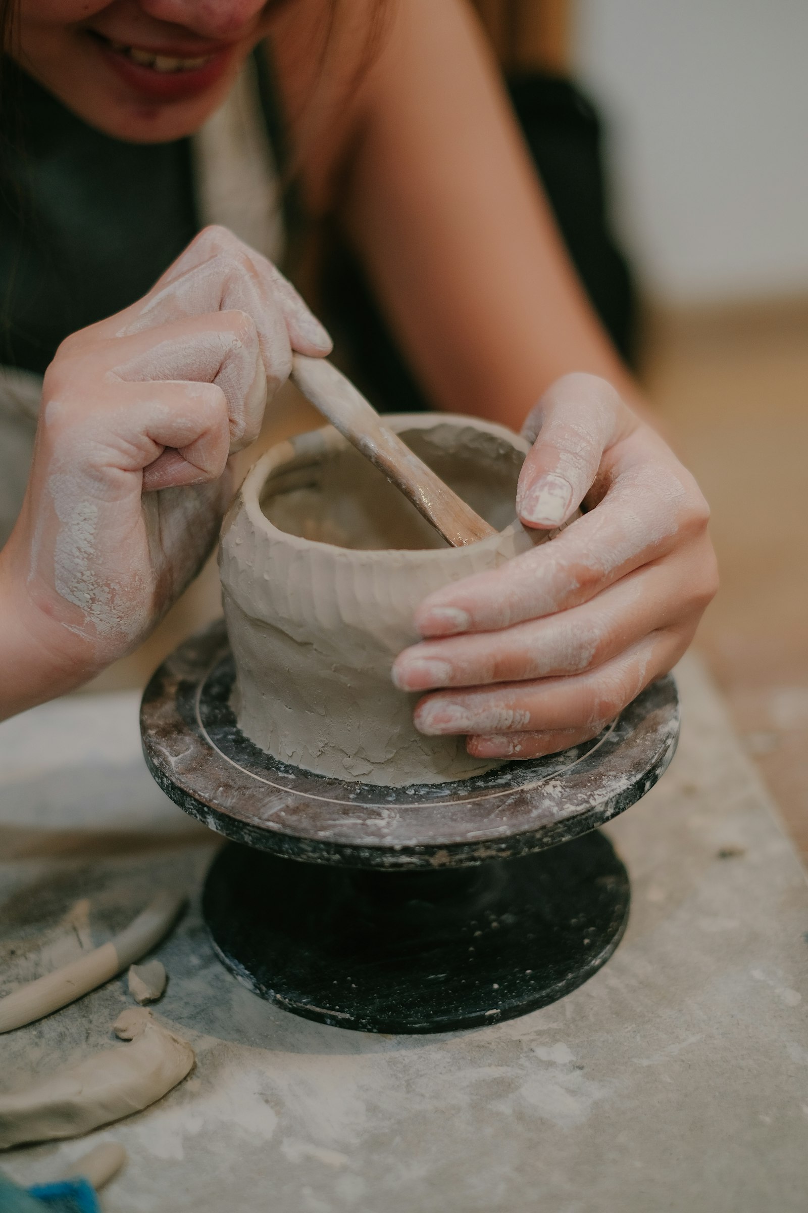 Sam Rivera shaping a clay vase on the wheel