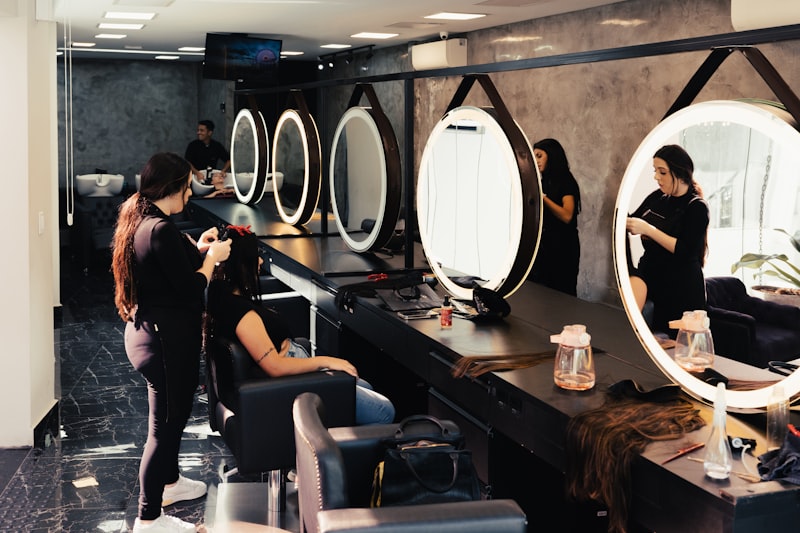 Clients at the round mirrors having their hair done
