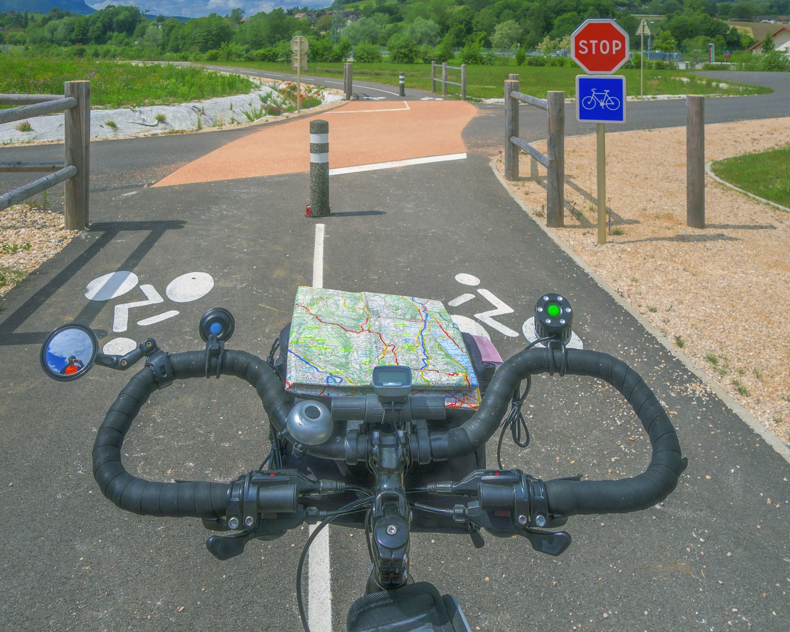 A paper trail map clipped to a bike's handlebars