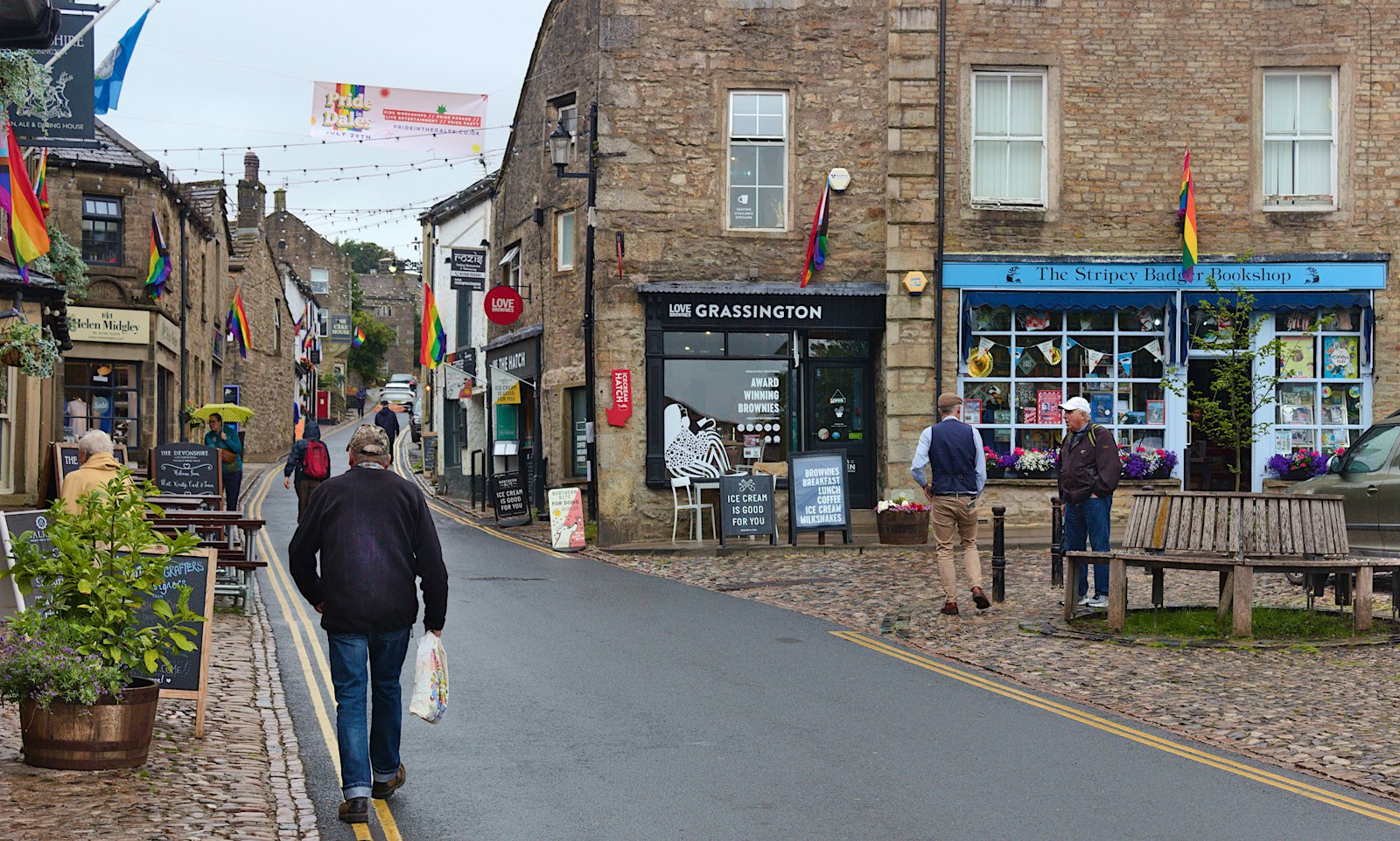 A market-town high street with stone shops and bunting