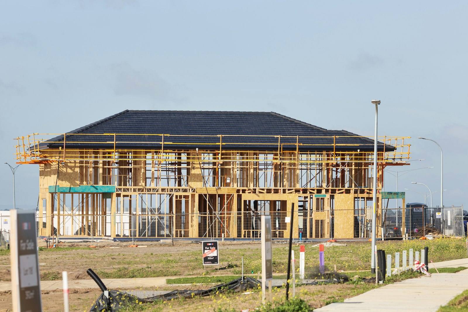 Timber-frame homes under construction with scaffolding