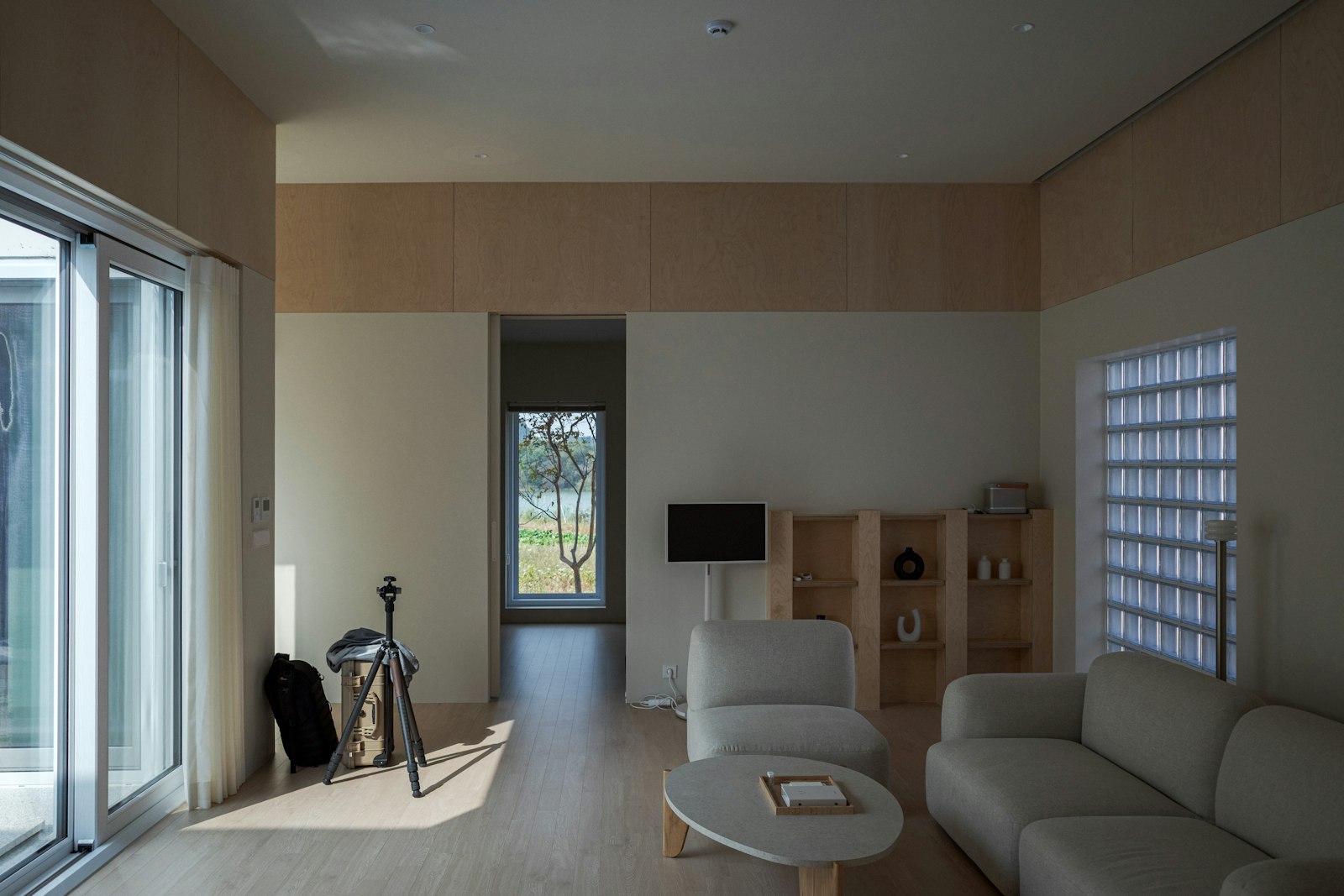 A bright minimal room with glass blocks and a sliding door