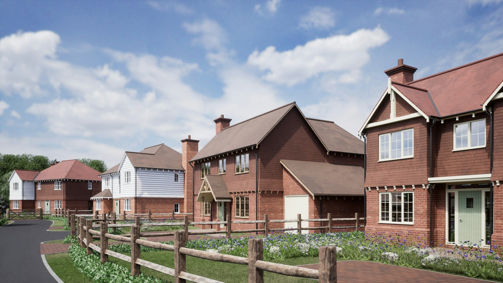 New-build brick houses behind a post-and-rail fence