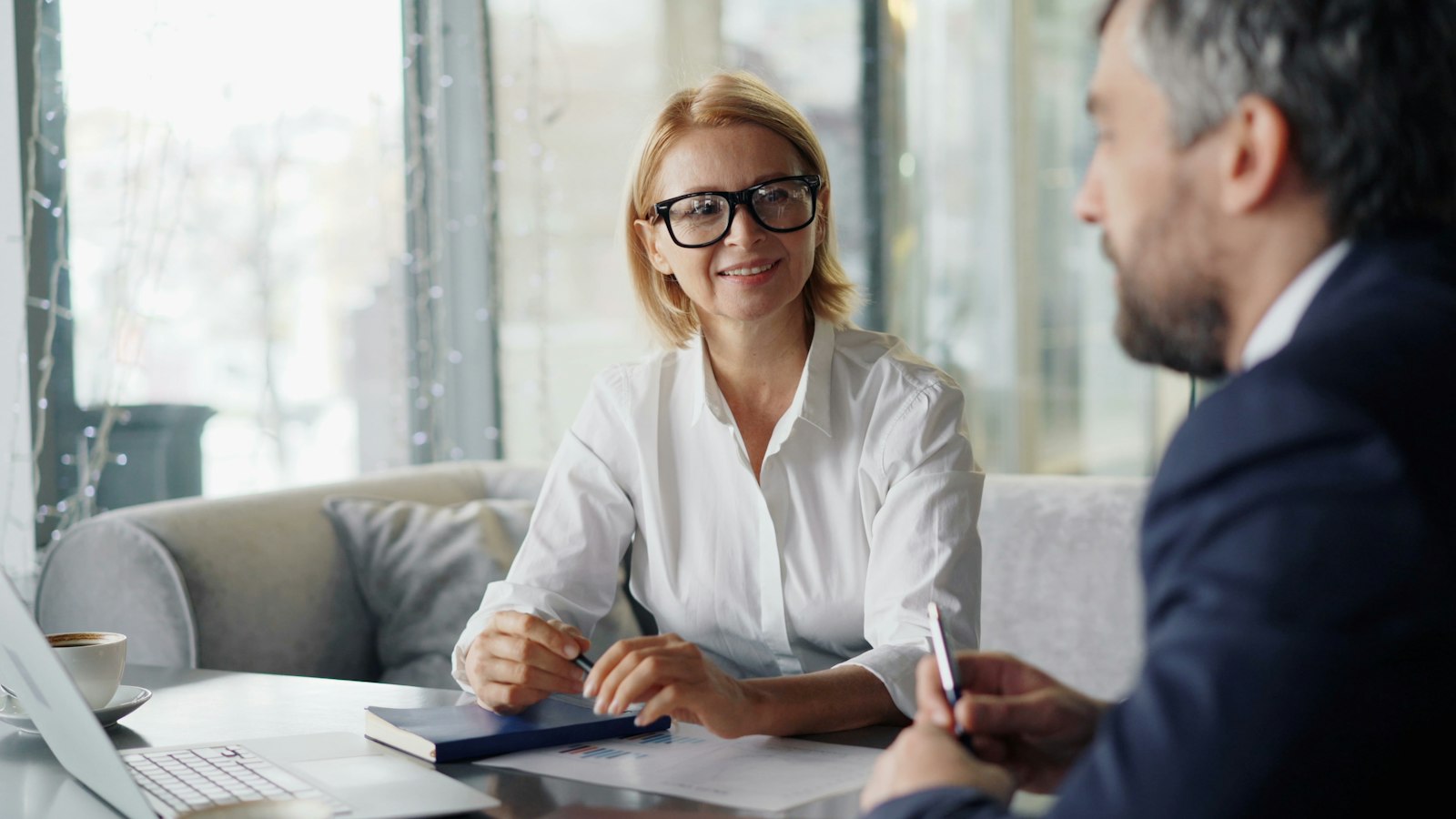 An adviser and a client talking across a table