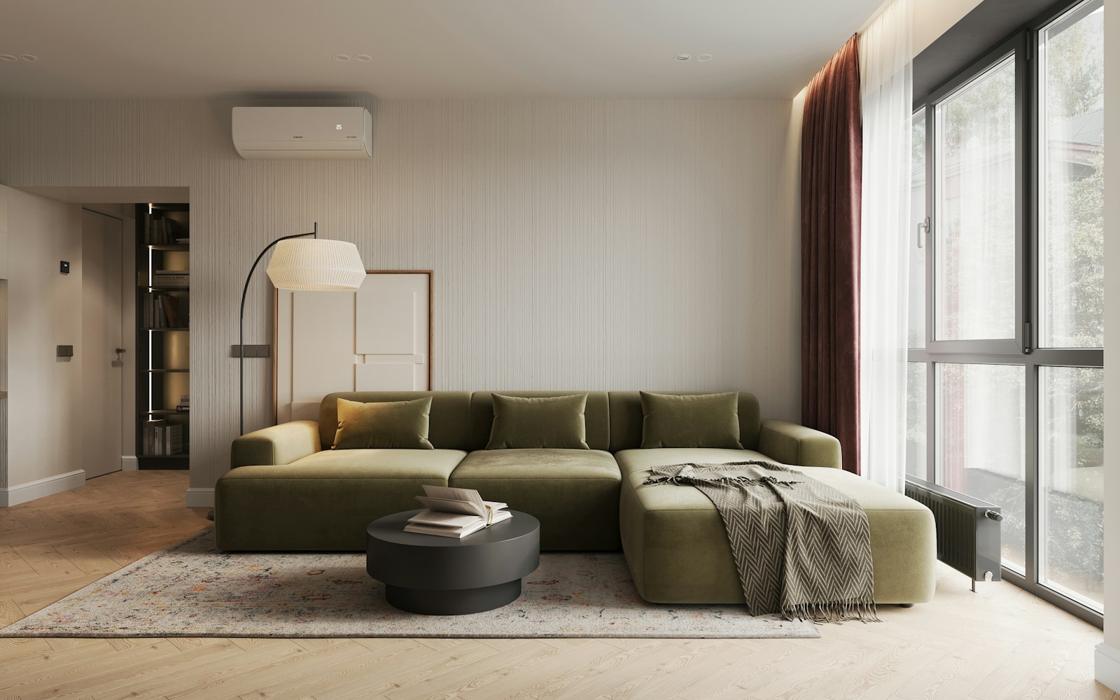 An olive green sofa in a pale room with sheer curtains