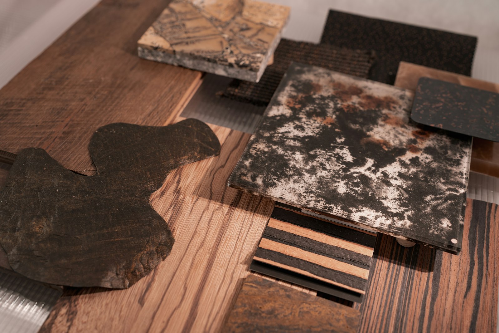 Stone and timber samples laid out on a wooden table