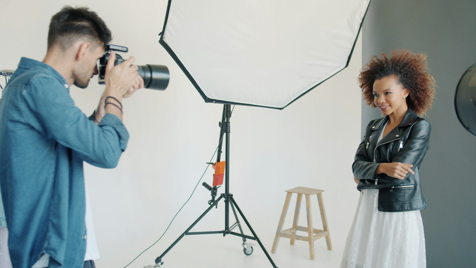 The photographer shooting a model under a softbox in the studio
