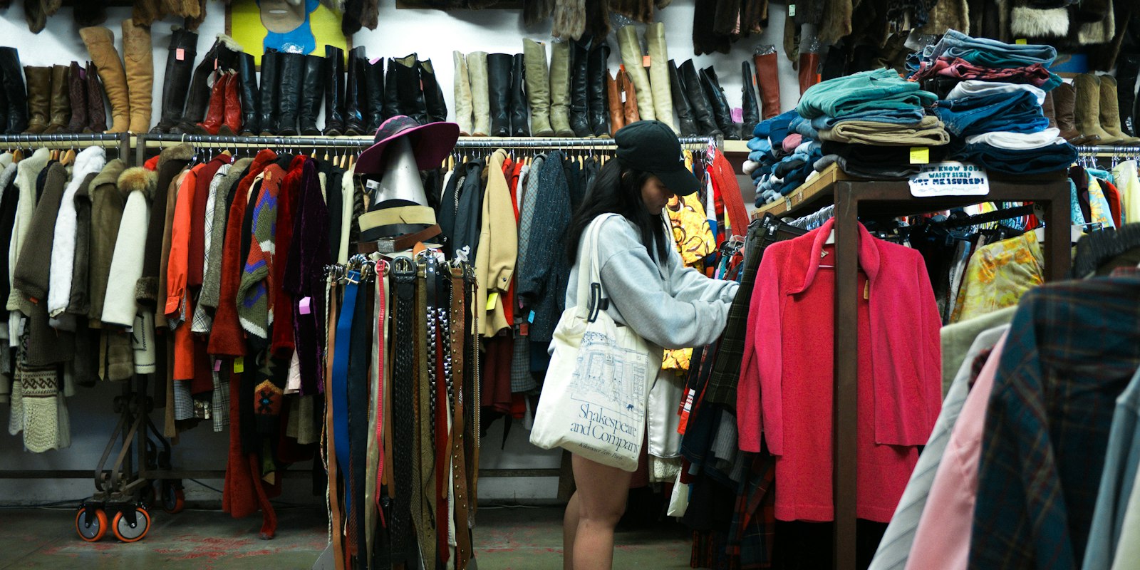 A woman browsing rails in a second-hand shop