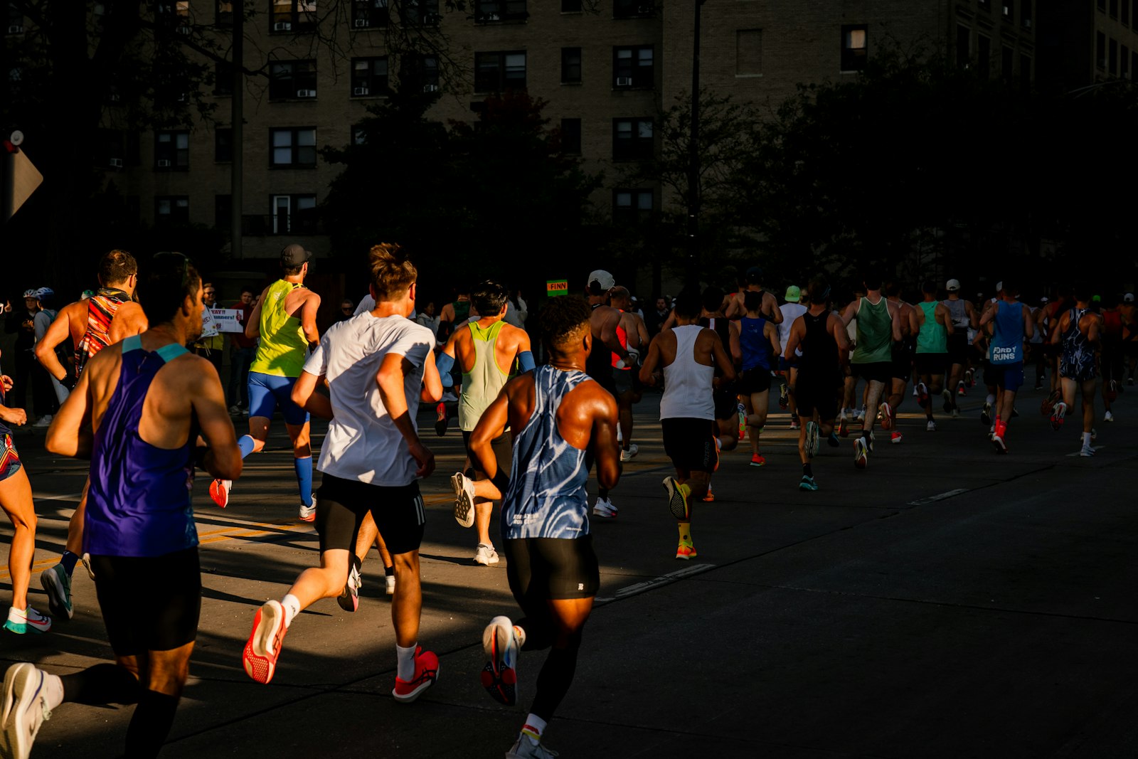A pack of runners in low golden light