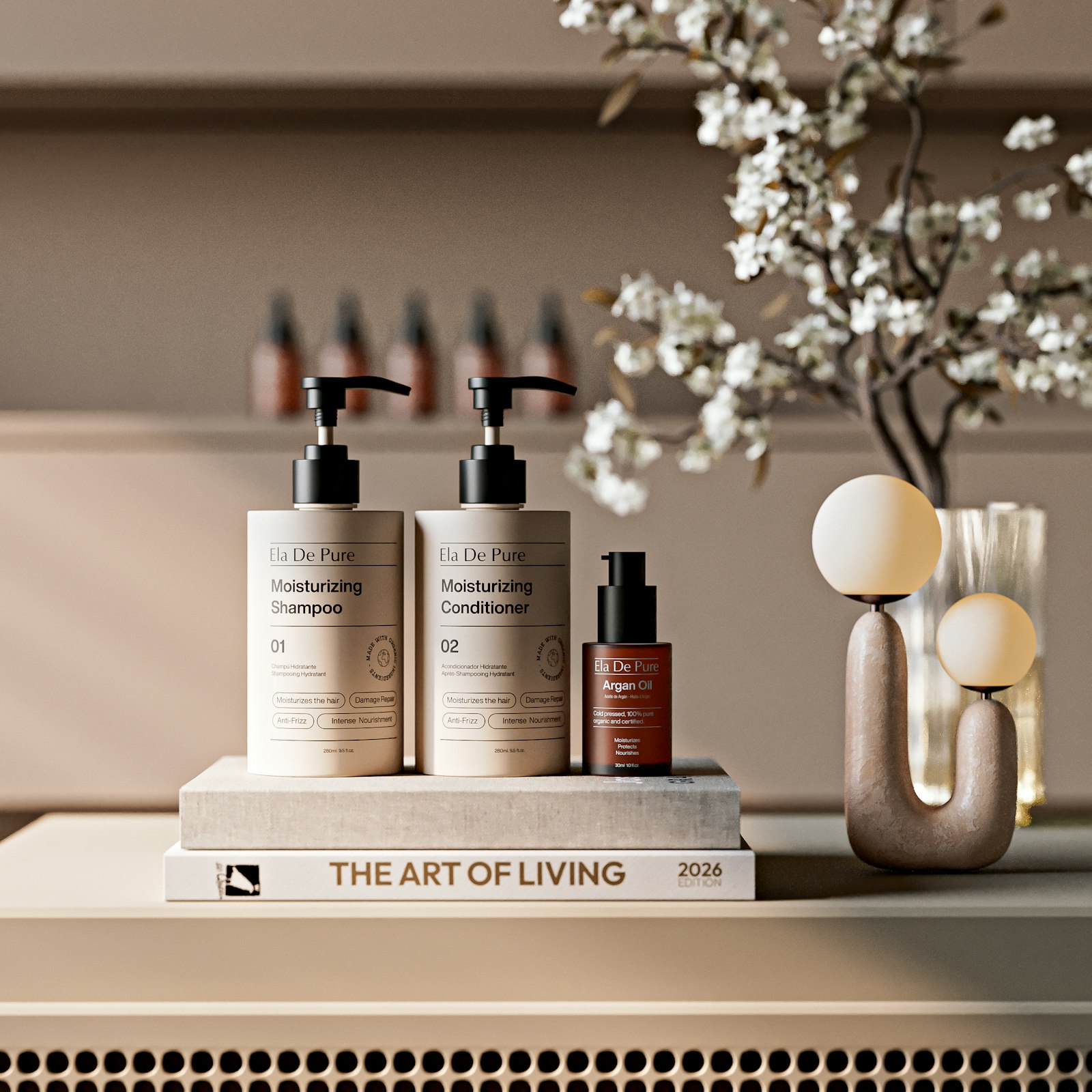 Three skincare bottles on a book beside a sprig of blossom