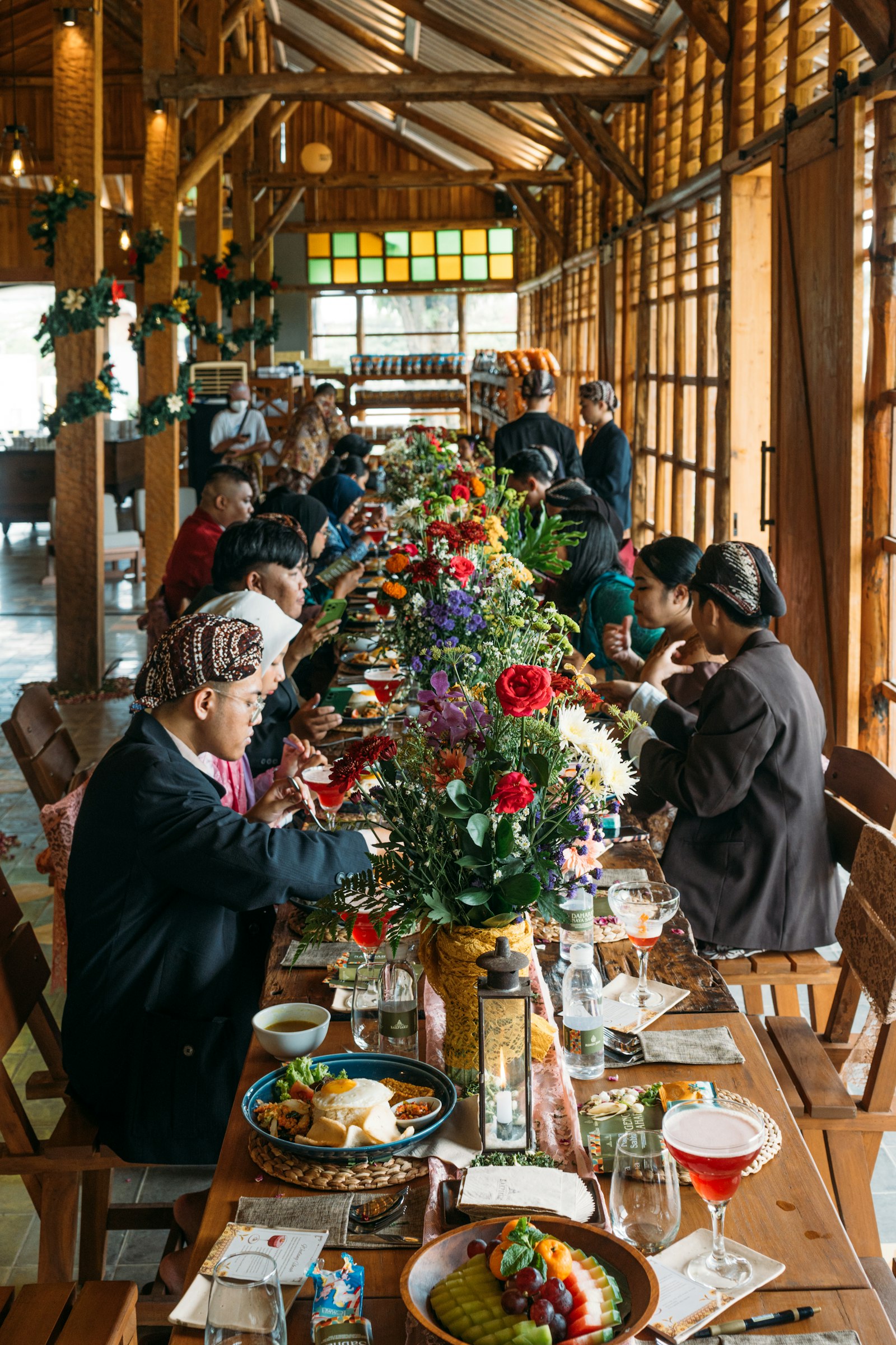 A long-table community lunch in a timber hall