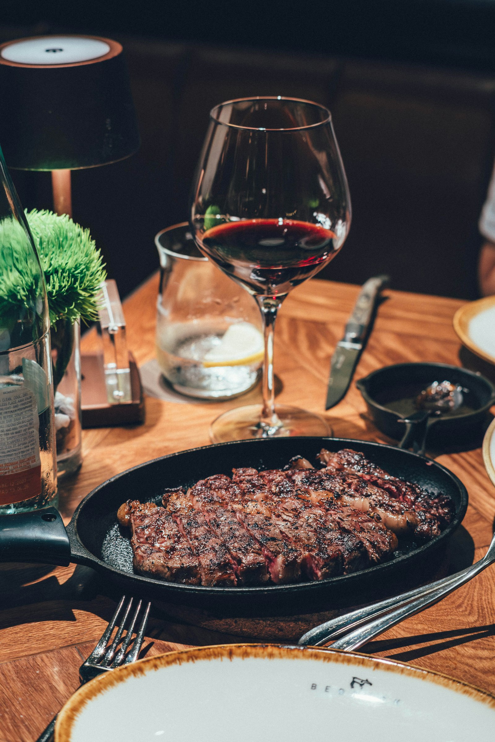 A steak in a cast-iron pan with red wine