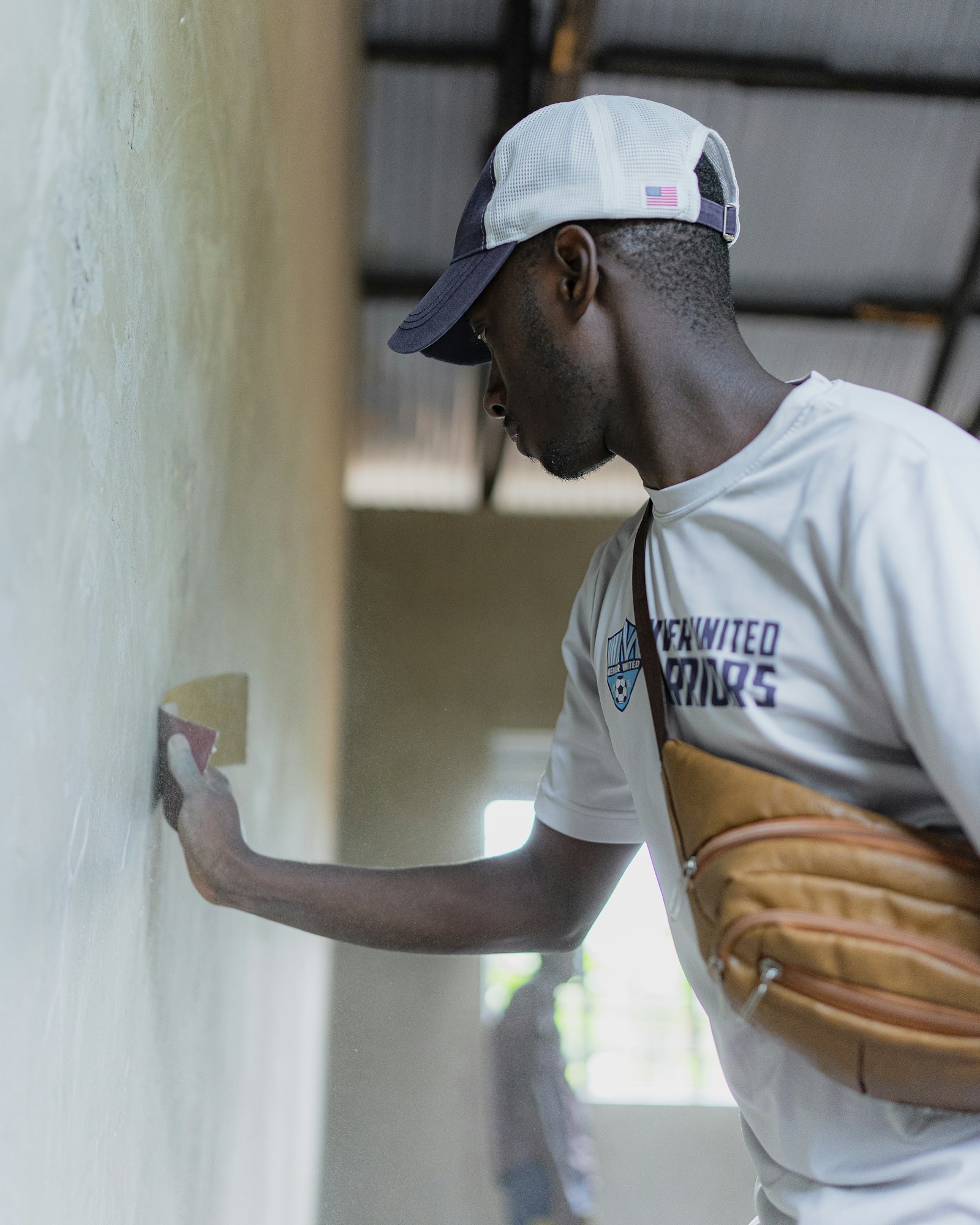 A plasterer skimming a wall with a trowel